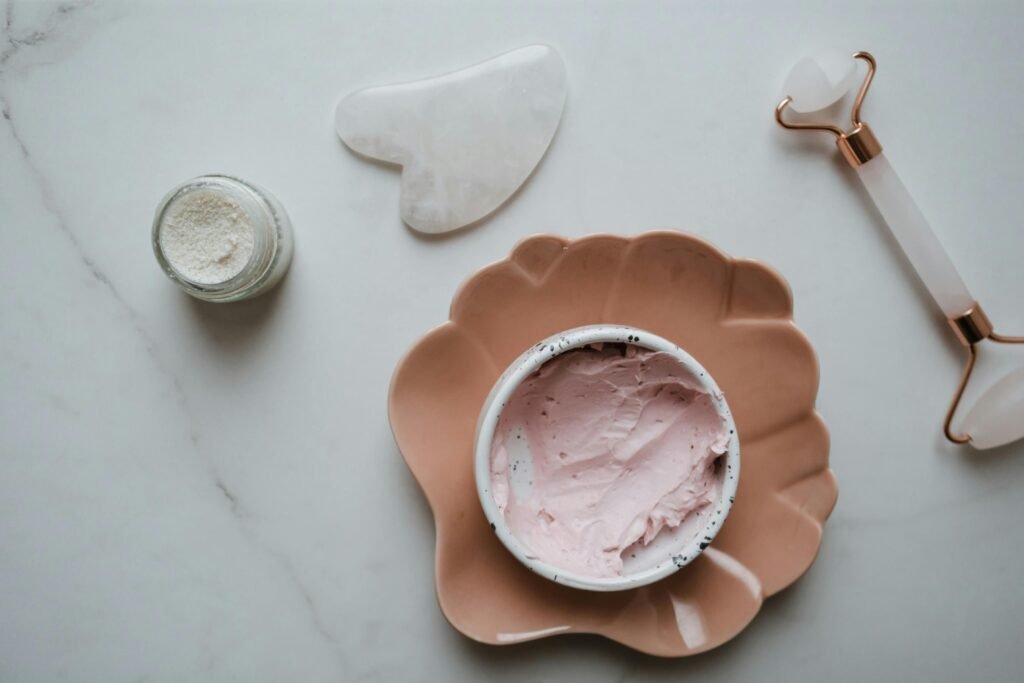 pexels-photo-5928039-5928039 Elegant top view of skincare essentials including cream, gua sha, and roller on marble surface, perfect for beauty concepts.