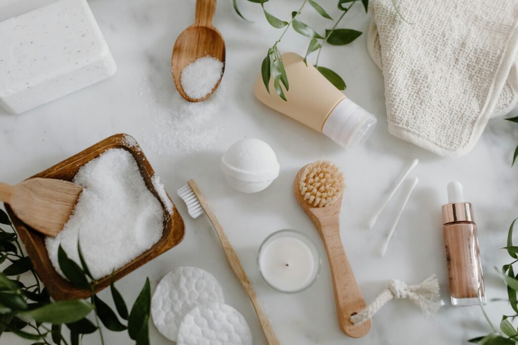pexels-photo-6690866-6690866 Flat lay of natural spa essentials including salts, soap, brush, and greenery.